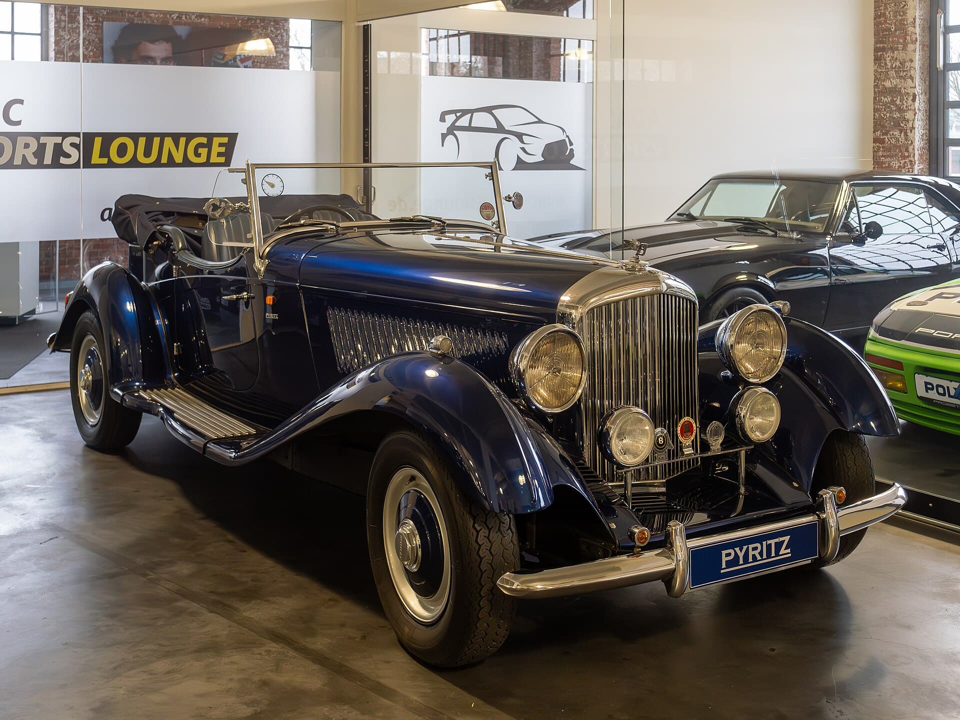 A classic car in a glazed storage bay